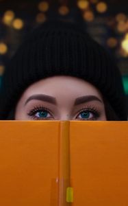 Preview wallpaper girl, book, glance, eyes, face