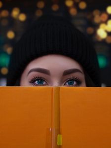 Preview wallpaper girl, book, glance, eyes, face