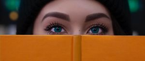 Preview wallpaper girl, book, glance, eyes, face