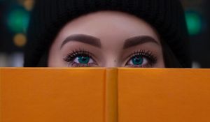 Preview wallpaper girl, book, glance, eyes, face