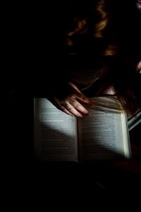 Preview wallpaper girl, book, reading, hand, dark