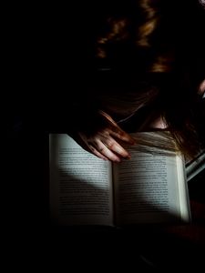 Preview wallpaper girl, book, reading, hand, dark