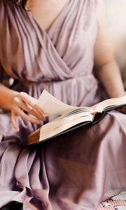 Preview wallpaper girl, book, reading, hand, dress