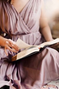 Preview wallpaper girl, book, reading, hand, dress