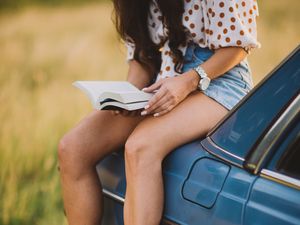 Preview wallpaper girl, book, sneakers, reading, car