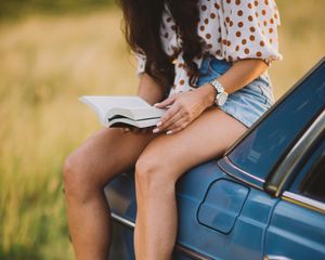 Preview wallpaper girl, book, sneakers, reading, car