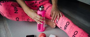 Preview wallpaper girl, bottle, dumbbells, fitness, sport, pink