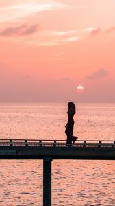Preview wallpaper girl, bridge, water, dusk, sunset