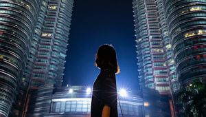 Preview wallpaper girl, building, skyscraper, night