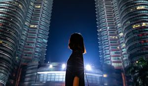 Preview wallpaper girl, building, skyscraper, night