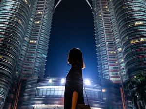 Preview wallpaper girl, building, skyscraper, night