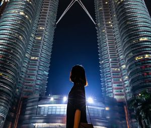 Preview wallpaper girl, building, skyscraper, night