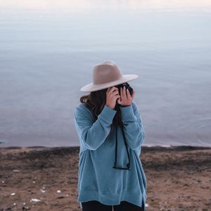 Preview wallpaper girl, camera, hat, photographer, nature