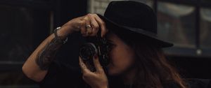 Preview wallpaper girl, camera, hat, photographer, tattoo