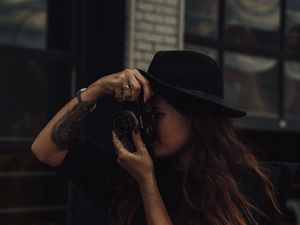 Preview wallpaper girl, camera, hat, photographer, tattoo