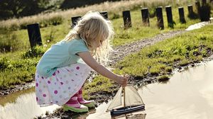 Preview wallpaper girl, child, boat, water, puddle, rain