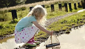 Preview wallpaper girl, child, boat, water, puddle, rain