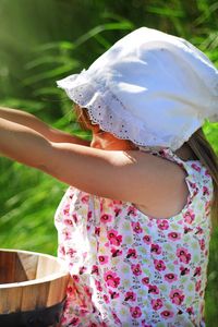 Preview wallpaper girl, child, flowers, bucket, water