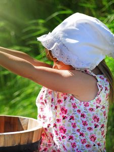 Preview wallpaper girl, child, flowers, bucket, water