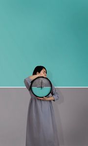 Preview wallpaper girl, clock, wall, symmetry, minimalism