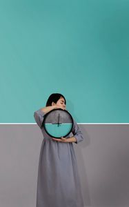 Preview wallpaper girl, clock, wall, symmetry, minimalism