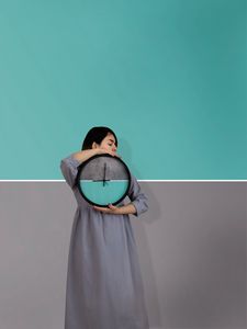 Preview wallpaper girl, clock, wall, symmetry, minimalism