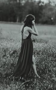 Preview wallpaper girl, dress, bw, field, blur, loneliness