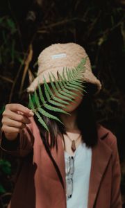 Preview wallpaper girl, fern, leaf, hand, hat, style