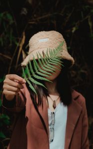 Preview wallpaper girl, fern, leaf, hand, hat, style