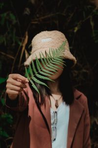 Preview wallpaper girl, fern, leaf, hand, hat, style