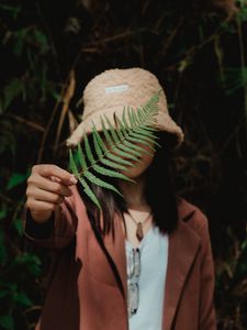 Preview wallpaper girl, fern, leaf, hand, hat, style