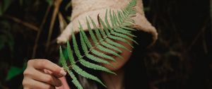 Preview wallpaper girl, fern, leaf, hand, hat, style