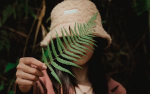Preview wallpaper girl, fern, leaf, hand, hat, style