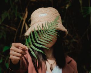 Preview wallpaper girl, fern, leaf, hand, hat, style