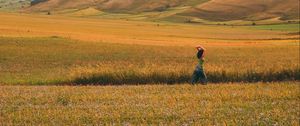 Preview wallpaper girl, field, hills, grass, flowers