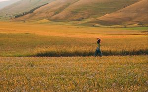 Preview wallpaper girl, field, hills, grass, flowers