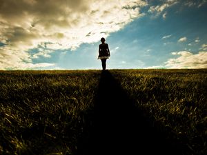 Preview wallpaper girl, field, walking, grass, dark