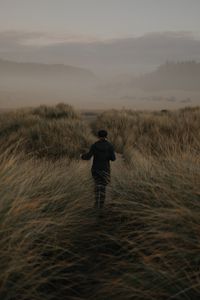 Preview wallpaper girl, hat, grass, fog