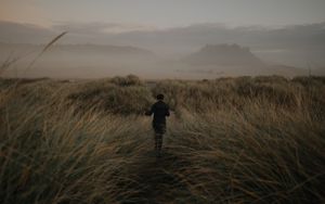 Preview wallpaper girl, hat, grass, fog