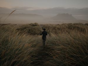Preview wallpaper girl, hat, grass, fog