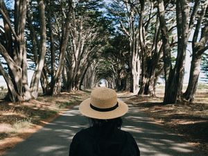 Preview wallpaper girl, hat, road, trees, aesthetics