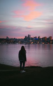 Preview wallpaper girl, loneliness, alone, city, sunset, water