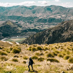 Preview wallpaper girl, mountains, grass, travel, tourist, queenstown, new zealand