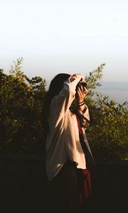 Preview wallpaper girl, photographer, camera, bushes