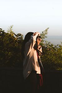 Preview wallpaper girl, photographer, camera, bushes