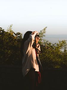 Preview wallpaper girl, photographer, camera, bushes