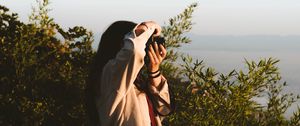 Preview wallpaper girl, photographer, camera, bushes