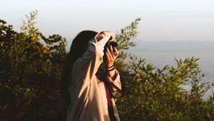 Preview wallpaper girl, photographer, camera, bushes