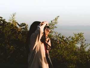 Preview wallpaper girl, photographer, camera, bushes