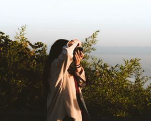 Preview wallpaper girl, photographer, camera, bushes